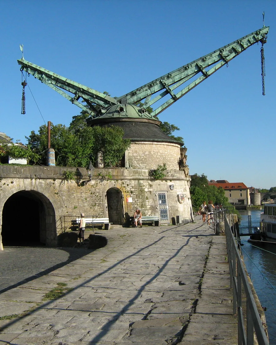 Ein Ausflugsschiff legt am Alten Kranen an, dahinter der Main